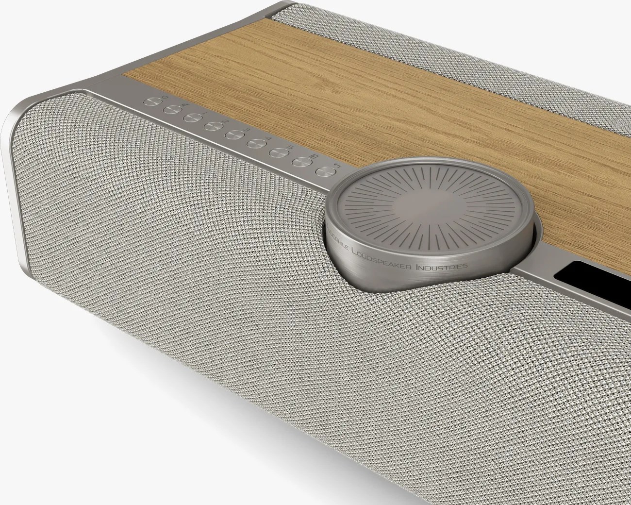 Rectangular speaker with light gray fabric grille, wooden top panel, and large round metallic control knob.