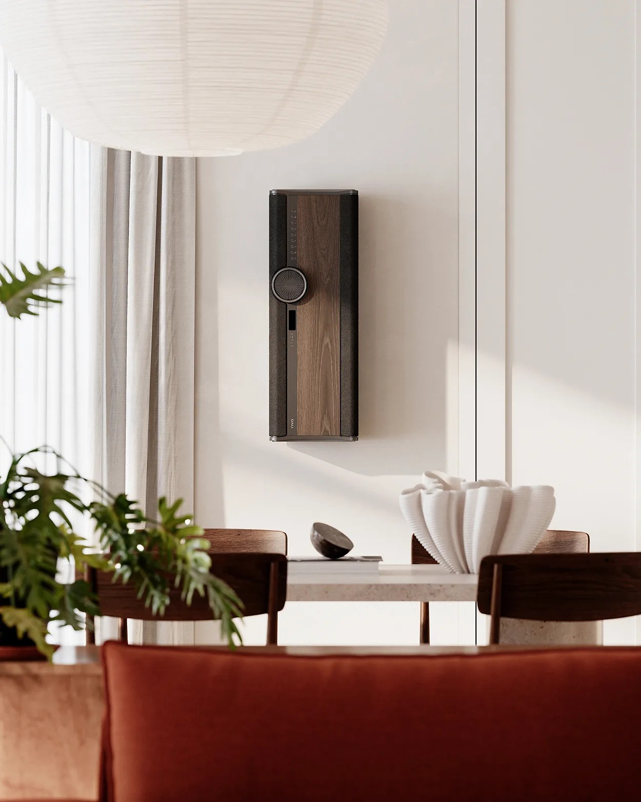 Wall-mounted vertical speaker with wood panel and black fabric sides in a modern dining room.