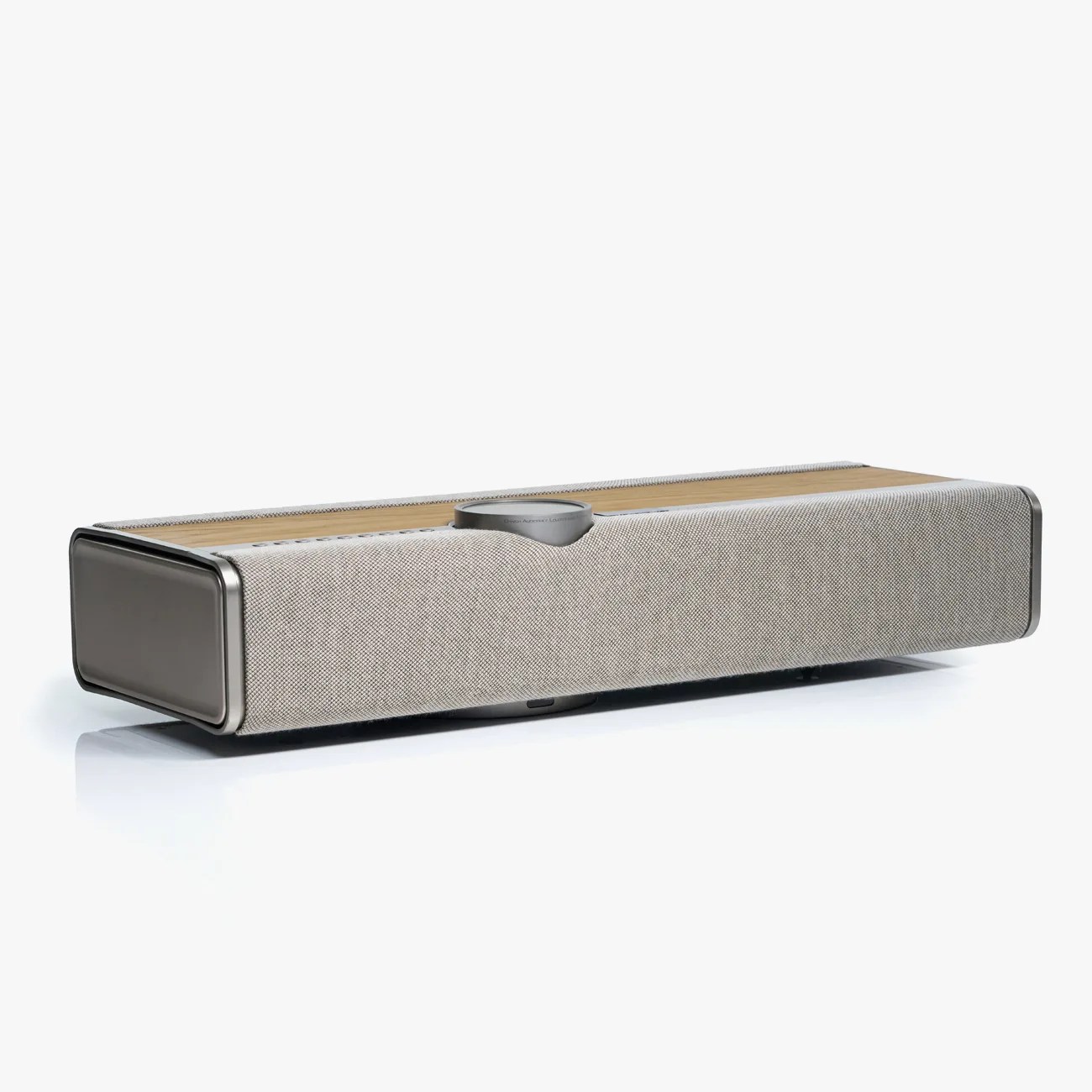 Rectangular speaker with light gray fabric cover and wooden top panel on a white surface.