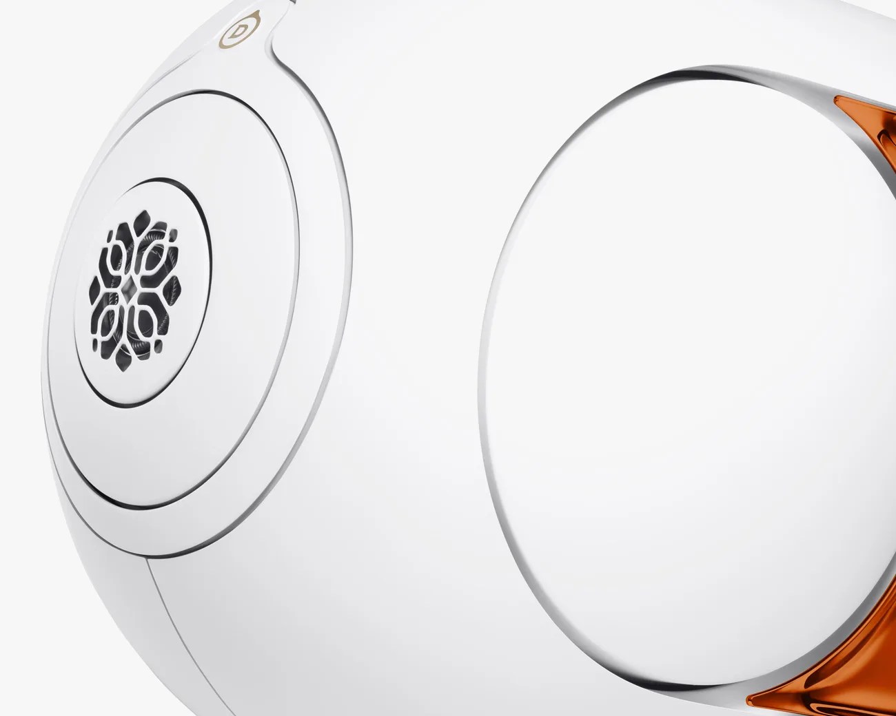 Close-up of a white spherical device with a decorative black grille and orange accents.