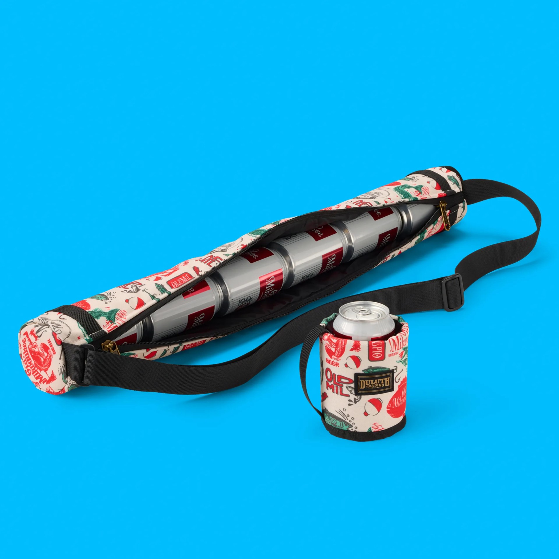 Canvas beer tote with red and green vintage-style prints holding six cans and a matching insulated can holder with a black strap.