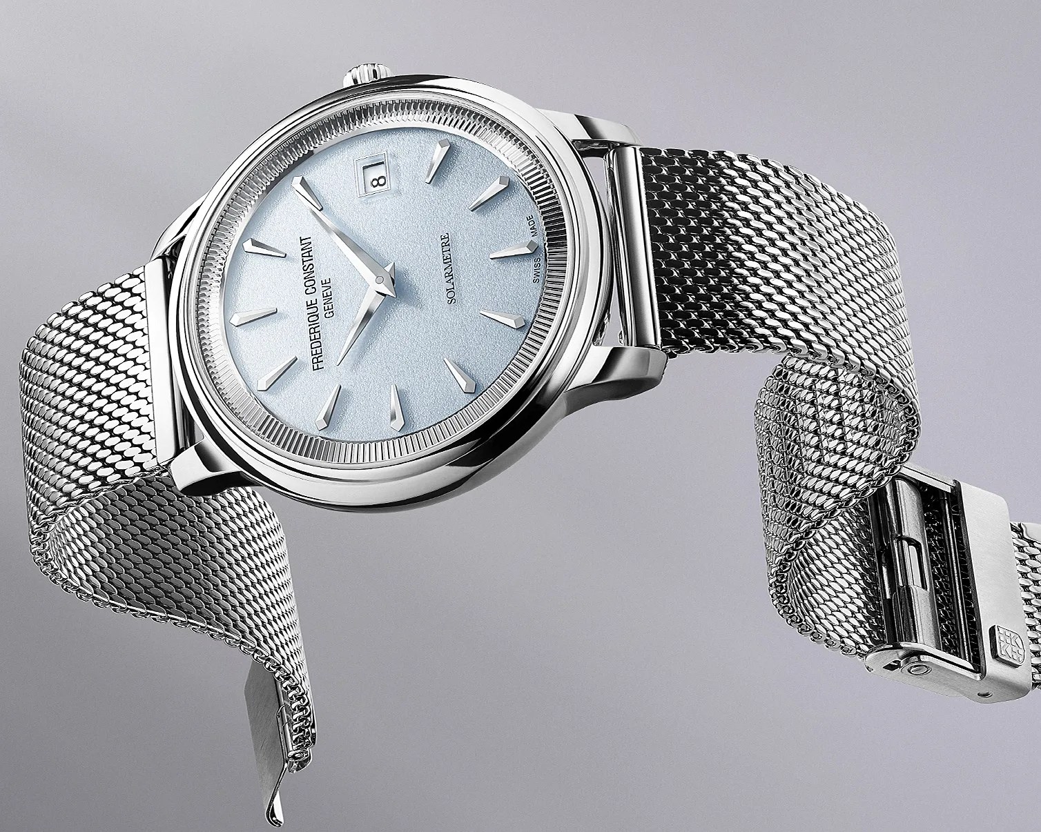Silver Frederique Constant wristwatch with light blue textured dial and mesh metal strap.