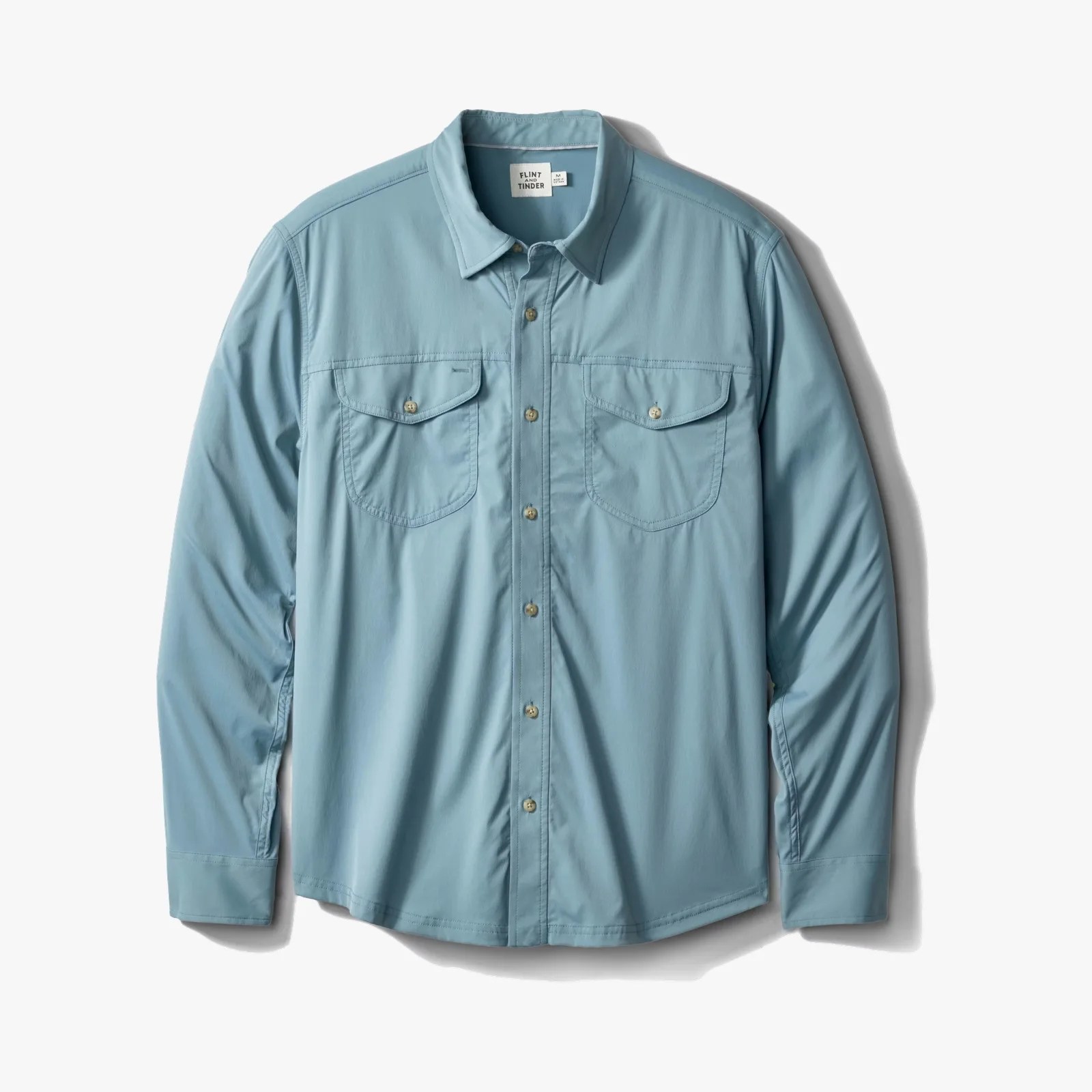 Light blue long-sleeve button-up shirt with two chest pockets and a collar.
