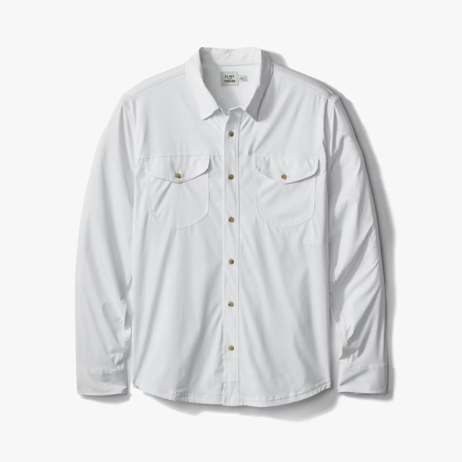 White long-sleeve button-up shirt with two front flap pockets and brown buttons.
