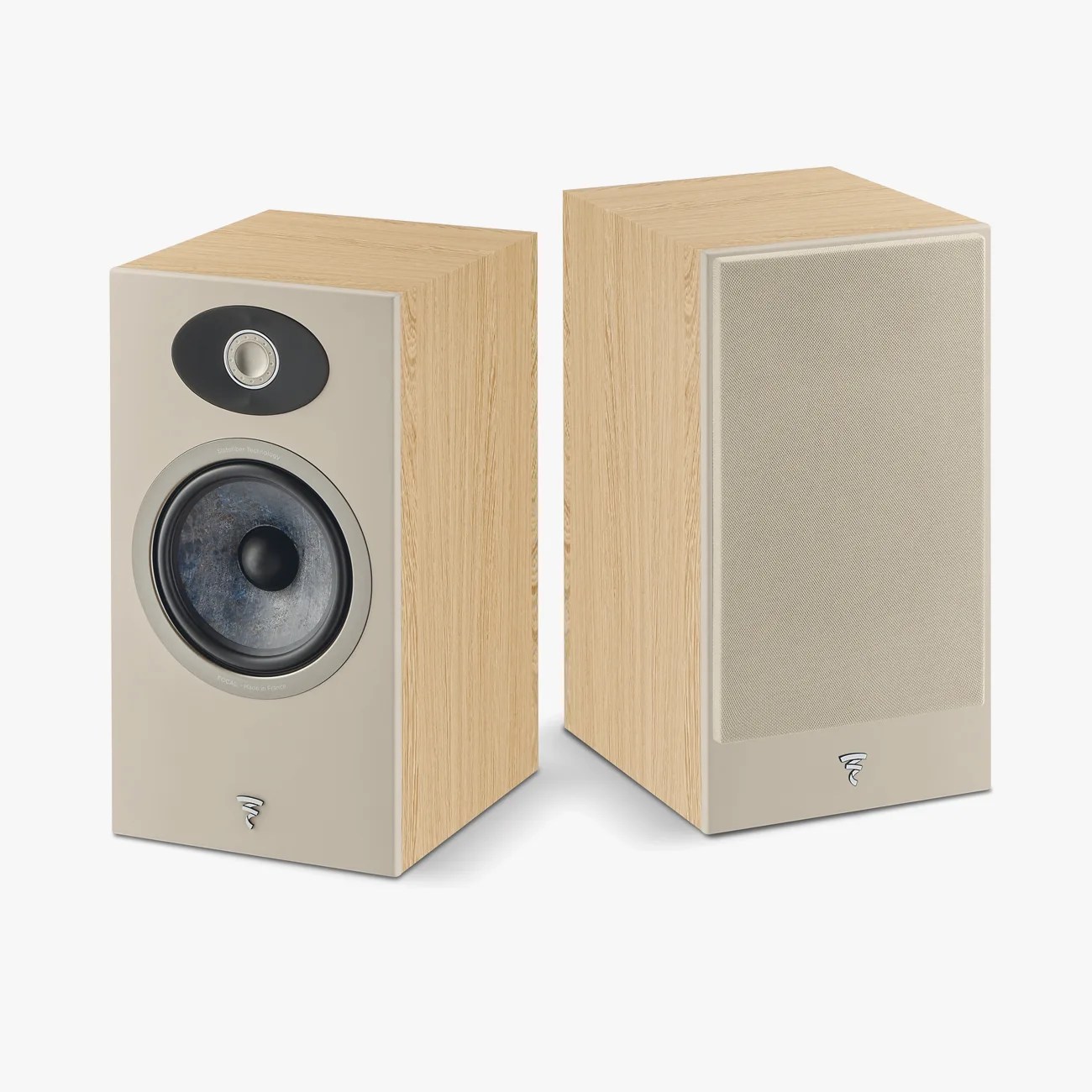 Pair of beige front panel bookshelf speakers with light wood finish and one speaker grille on.