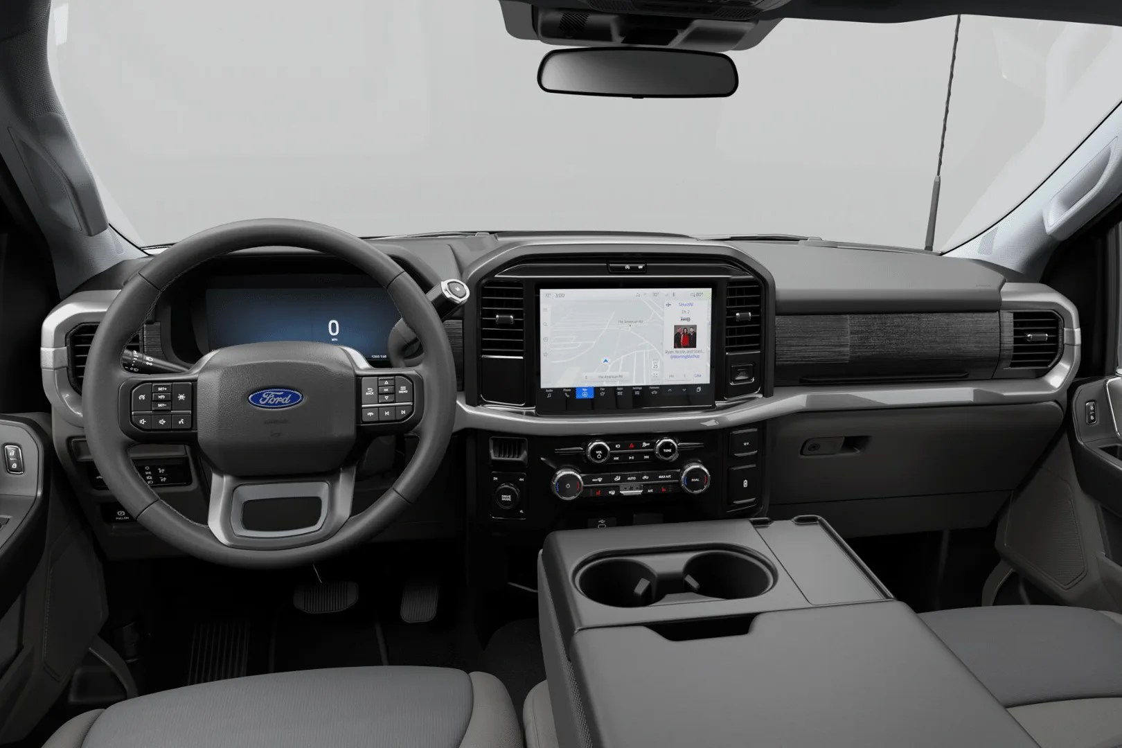 Interior view of a Ford vehicle dashboard with a digital instrument cluster, touchscreen infotainment system, and center console cup holders.
