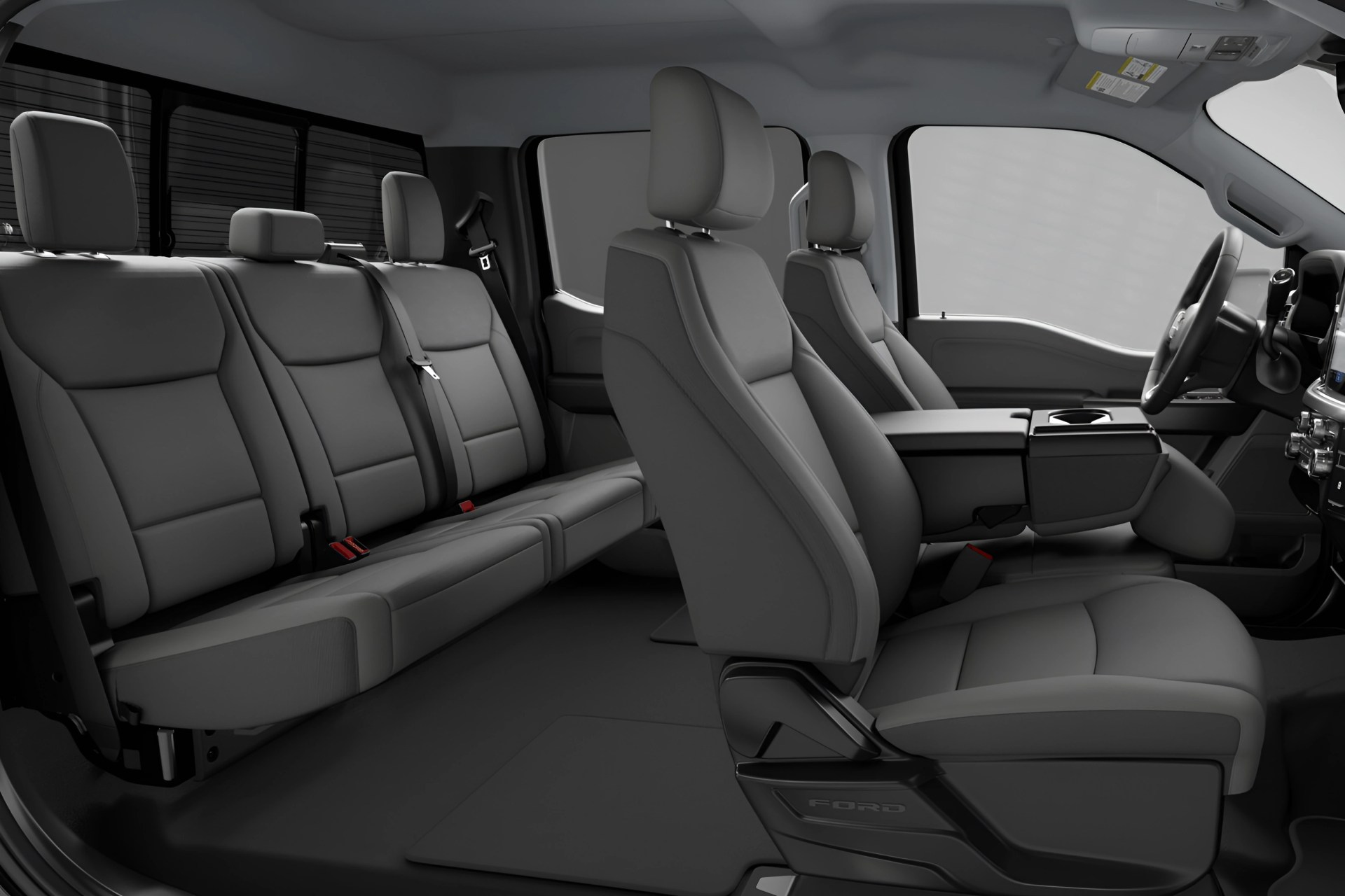 Gray leather interior of a Ford vehicle showing front bucket seats and a rear bench seat.