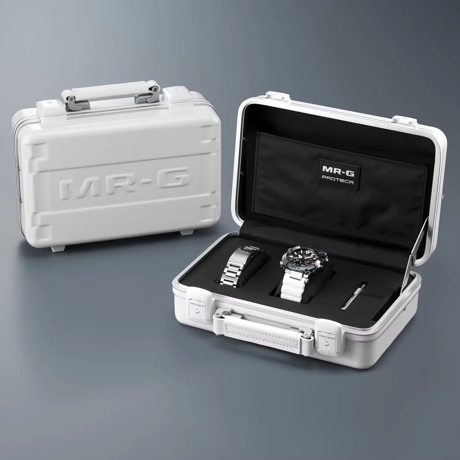 White hard-shell MR-G watch case with an open lid showing a watch, metal strap, and tool inside.