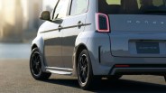 Rear side view of a gray Honda Super-ONE car with illuminated taillight and black alloy wheels.