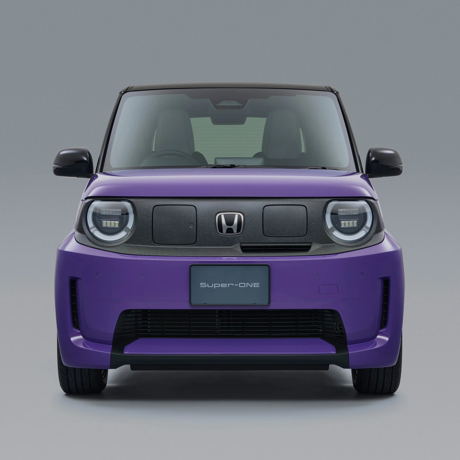 Front view of a purple Honda Super-ONE electric vehicle with black accents and round LED headlights.