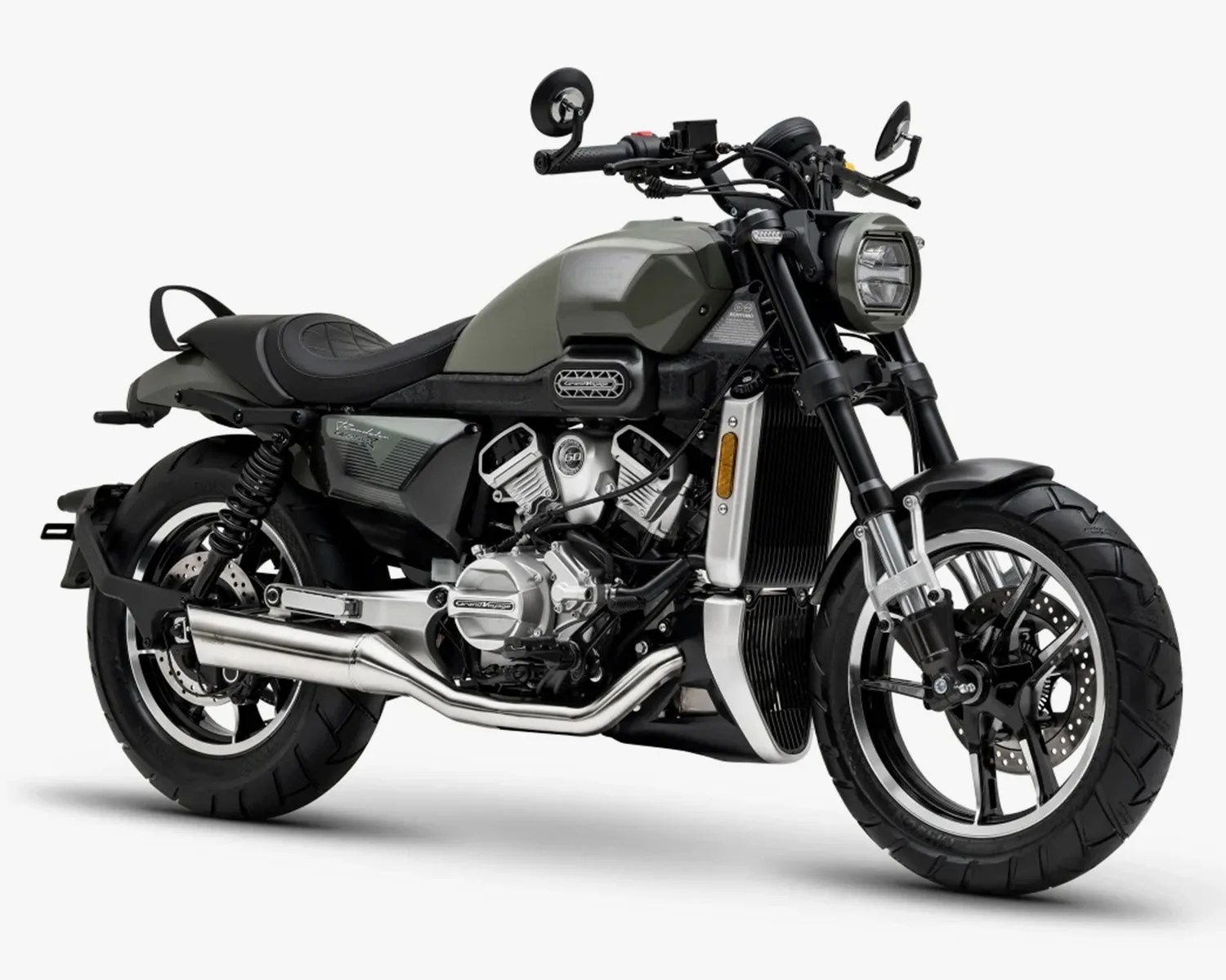 Matte green and black cruiser motorcycle with dual exhaust pipes and round headlight.