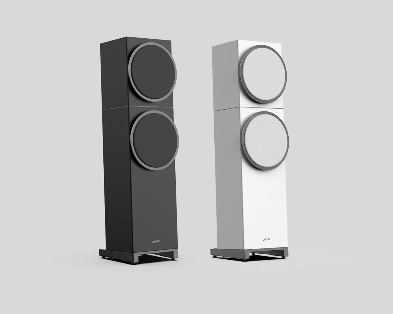 Two tall rectangular floor-standing speakers, one black and one white, each with two large circular drivers and a metal base.