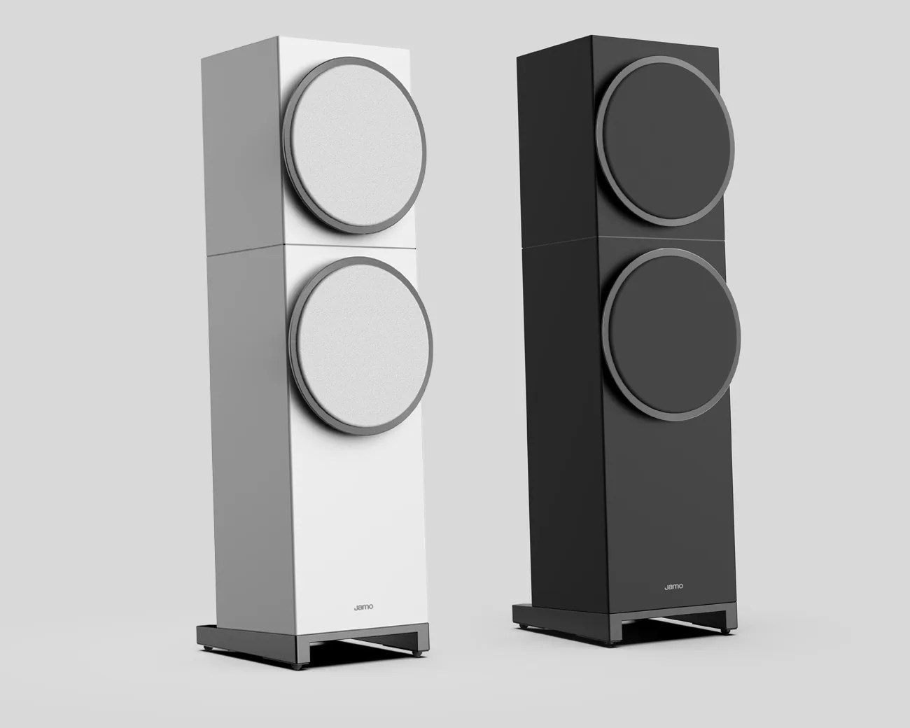 Pair of tall rectangular floor-standing speakers, one white and one black, each with two large circular drivers and a metal base.