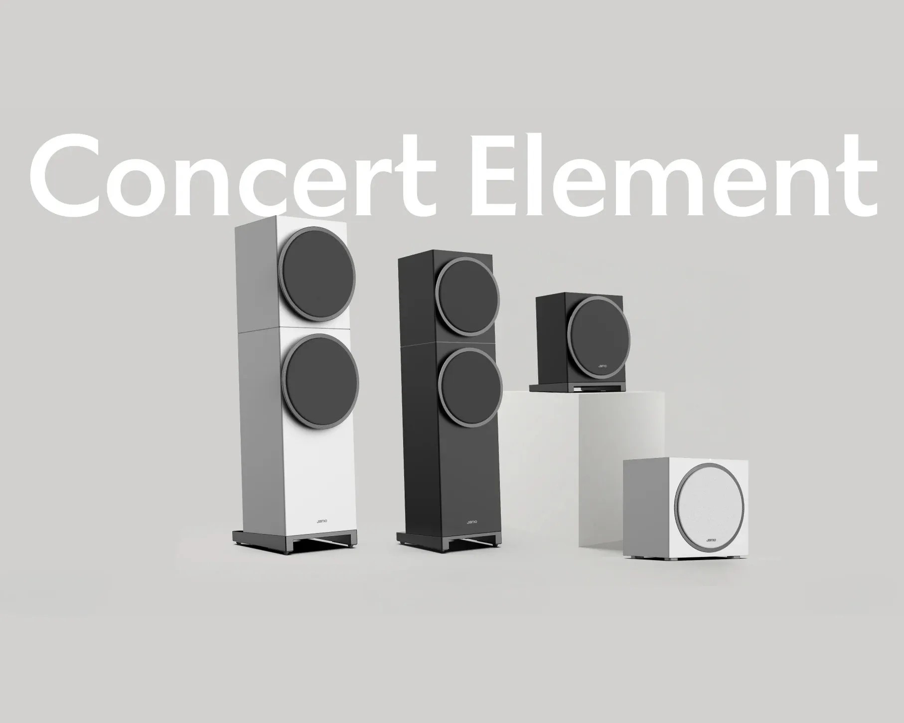 Four modern Jamo Concert Element speakers in black and white, arranged on white pedestals against a light gray background.