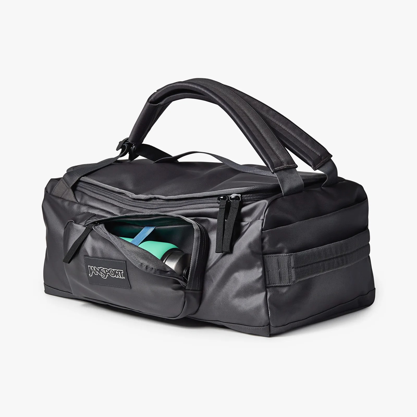 Black Jansport duffel bag with padded handles and a front zippered pocket containing a green water bottle.