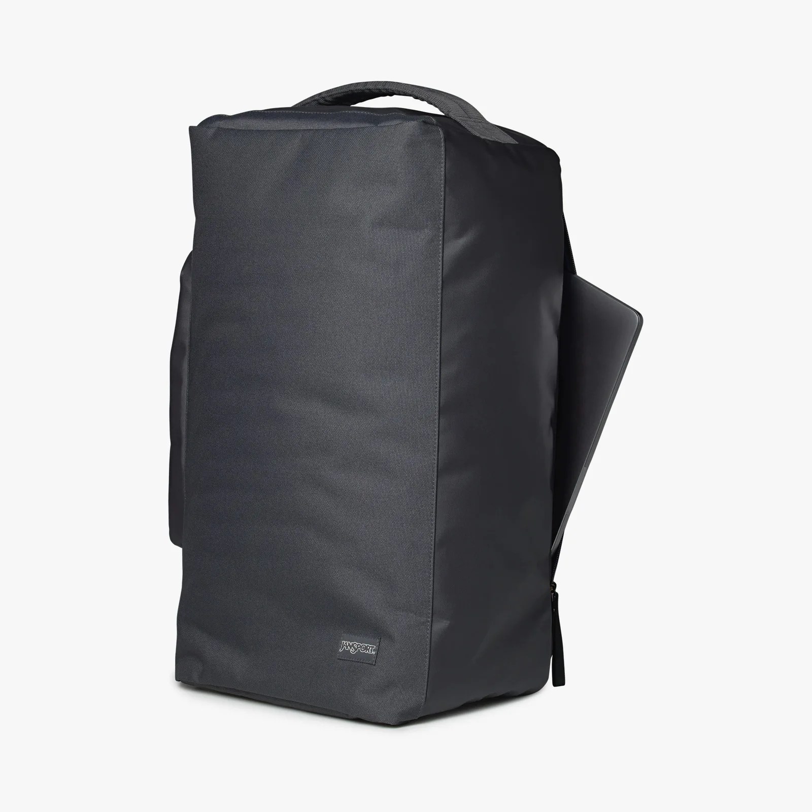 Black rectangular backpack with a top handle and a laptop partially inserted in a side zipper pocket.