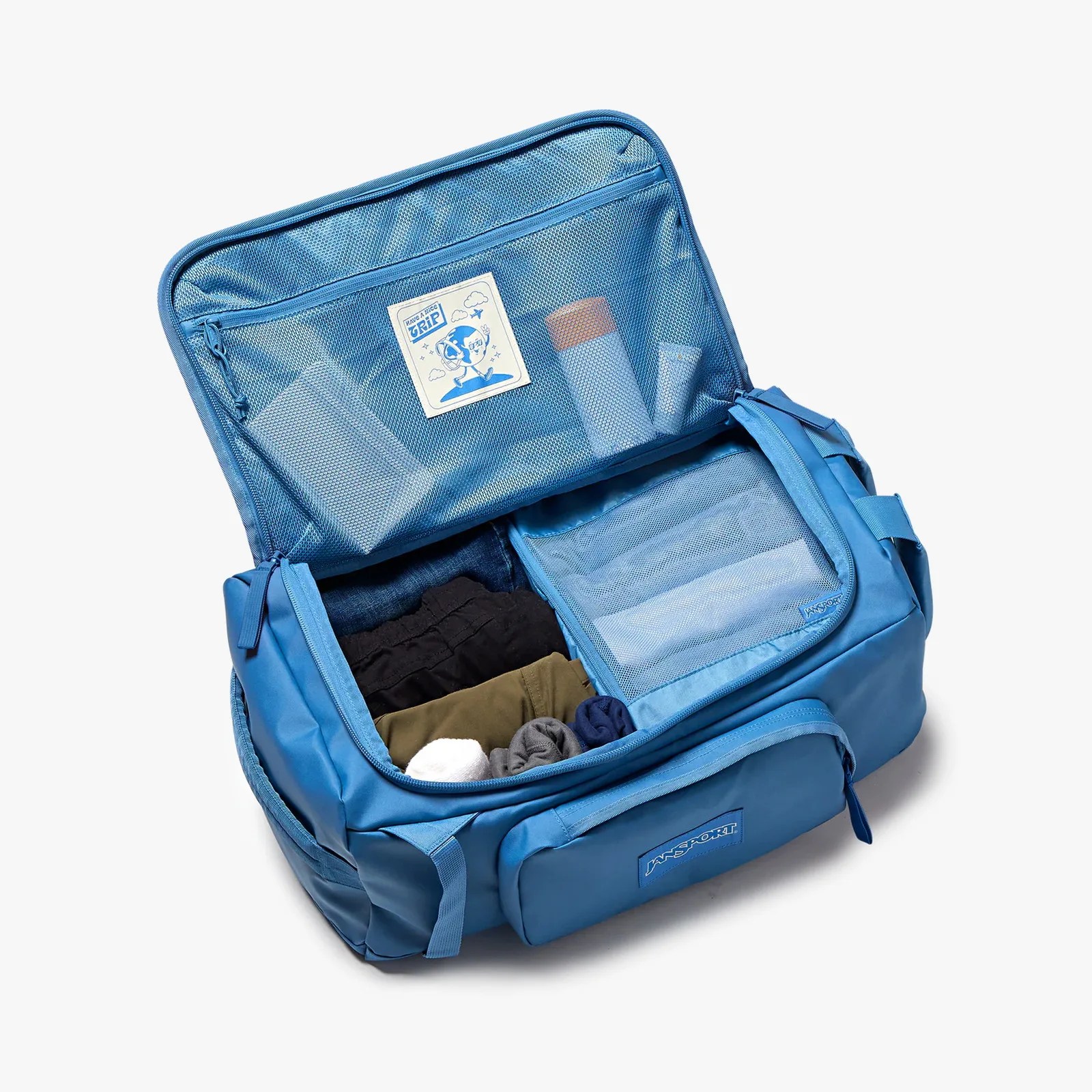 Blue Jansport duffel bag open to show organized clothes and toiletries in mesh compartments.