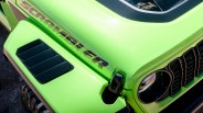 Bright green Jeep Scrambler 392 hood with black vent and round headlight.
