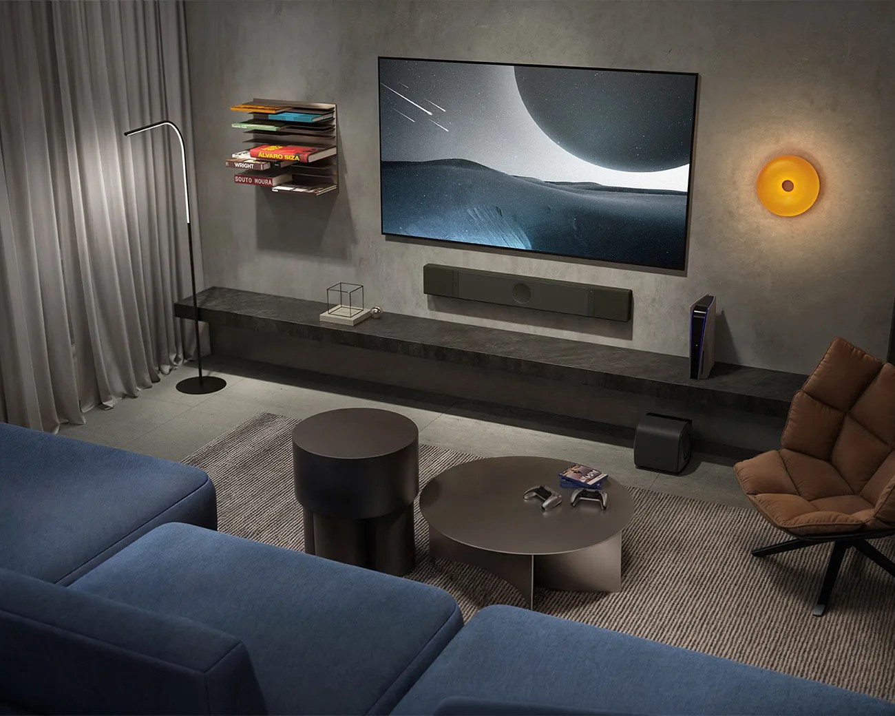 Modern living room with a large flat-screen TV, blue sectional sofa, brown cushioned chair, and round black coffee tables.