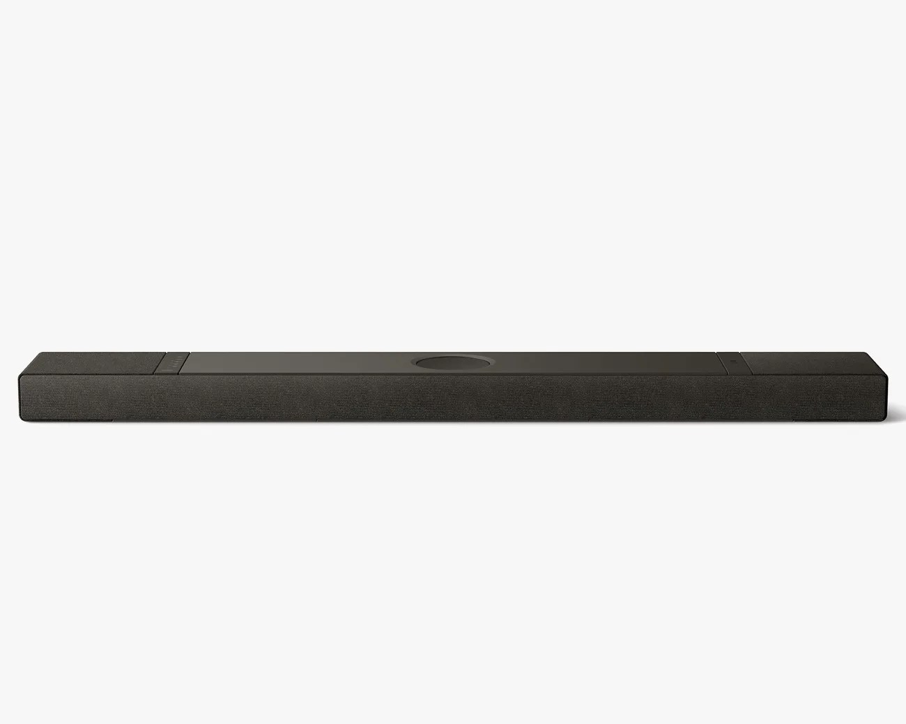 Black rectangular soundbar with fabric covering and a circular control panel in the center.