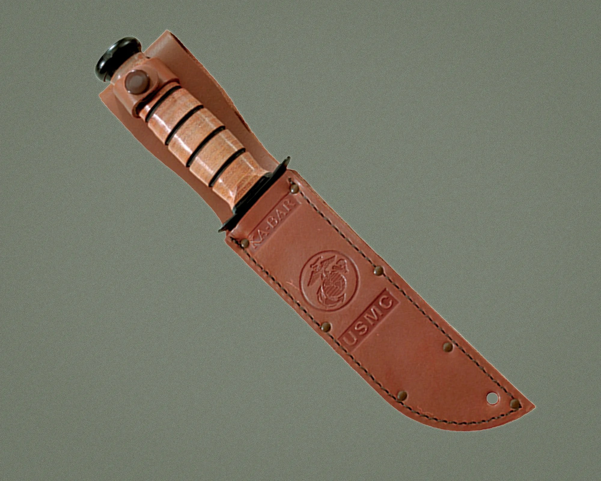 Leather sheath with embossed USMC logo holding a knife with a tan stacked leather handle.