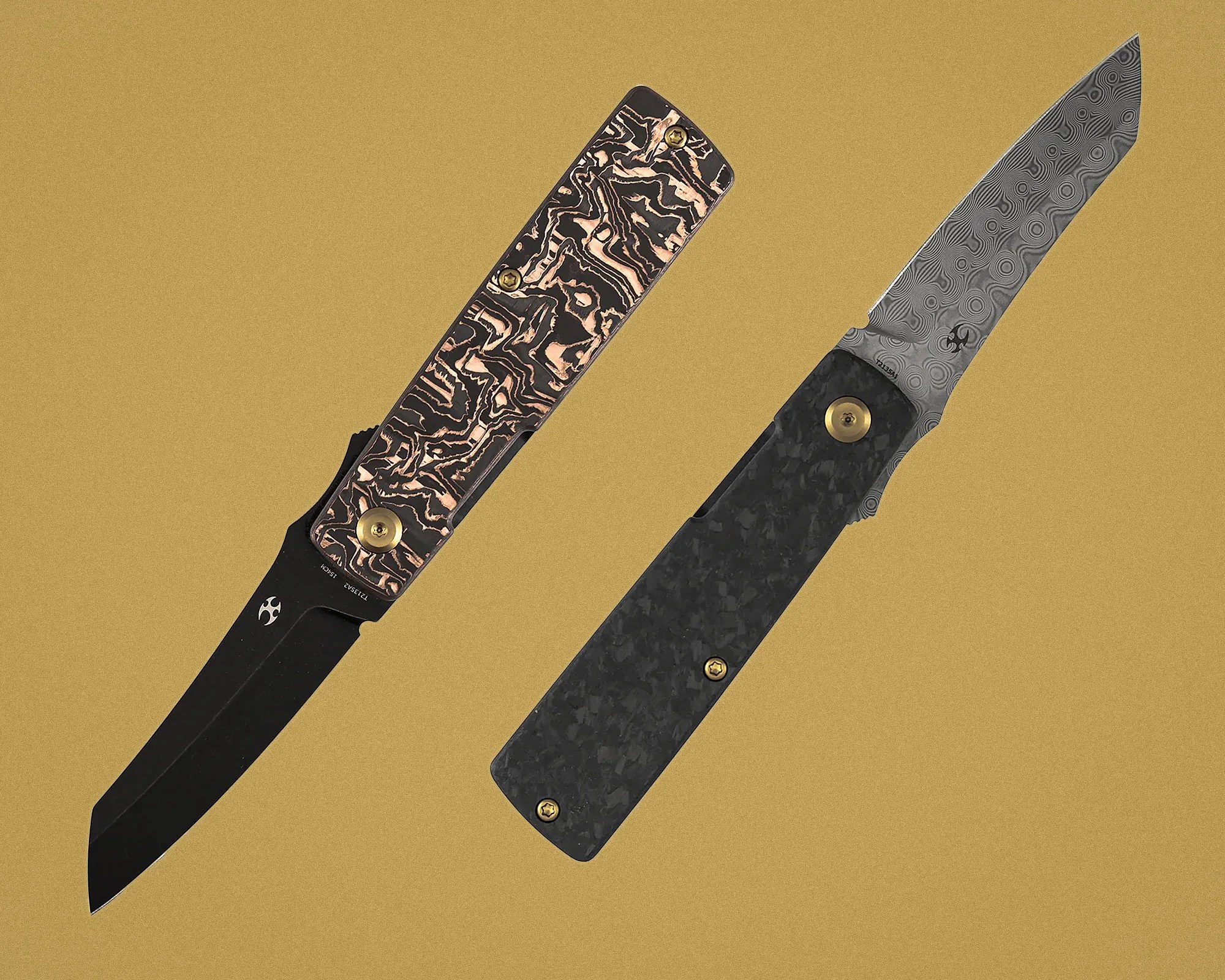 Two folding knives with patterned handles and blades, one with a black blade and copper-accented handle, the other with a Damascus steel blade and dark textured handle.