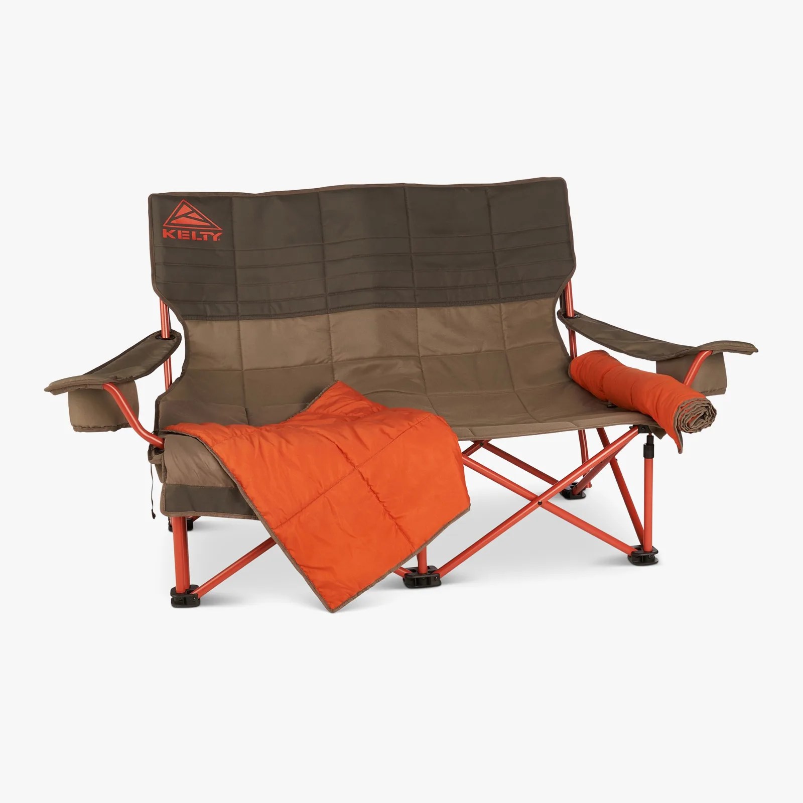 Brown and orange Kelty double camping chair with armrests and an orange blanket draped over it.