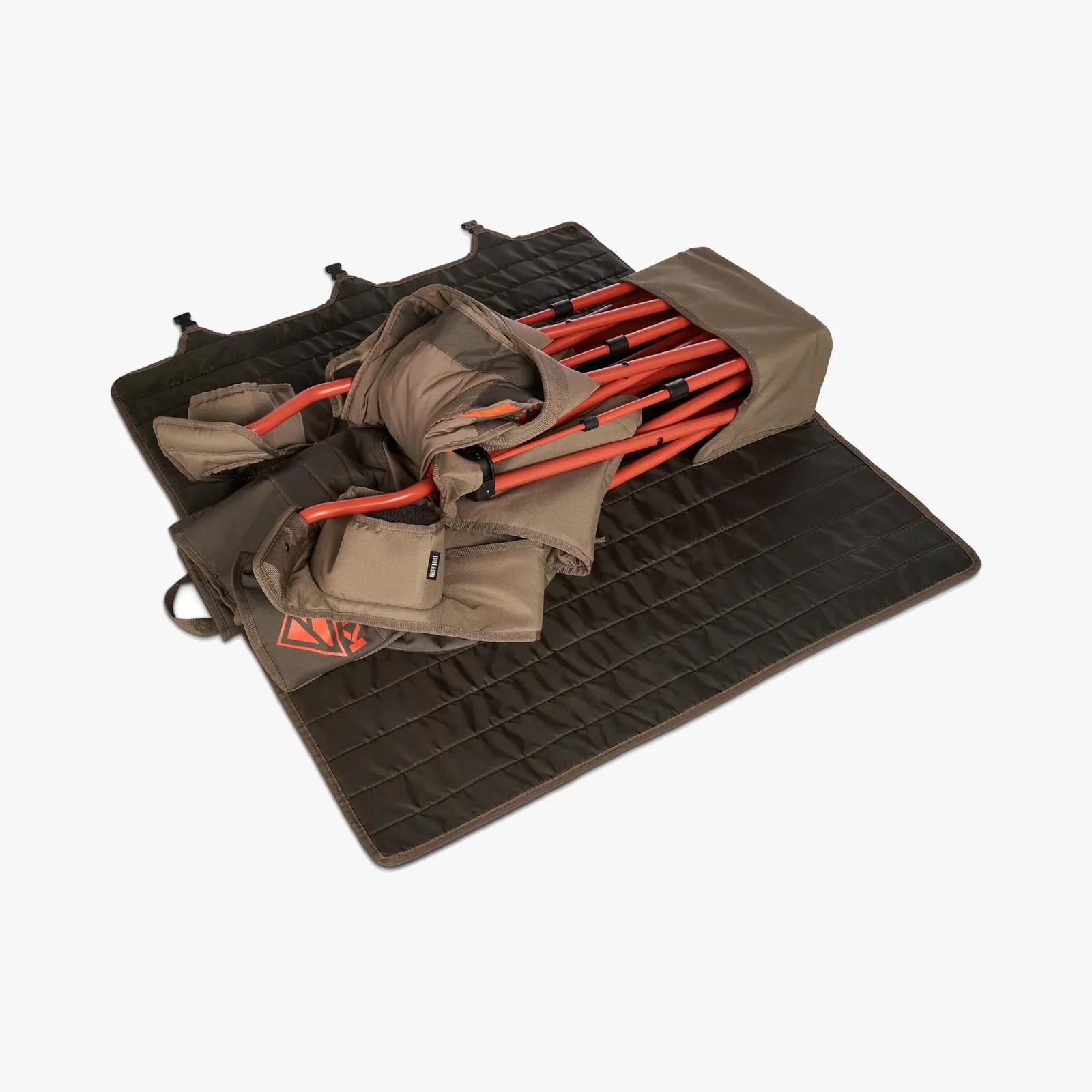 Folded brown camping chair with orange metal frame on a black quilted mat.