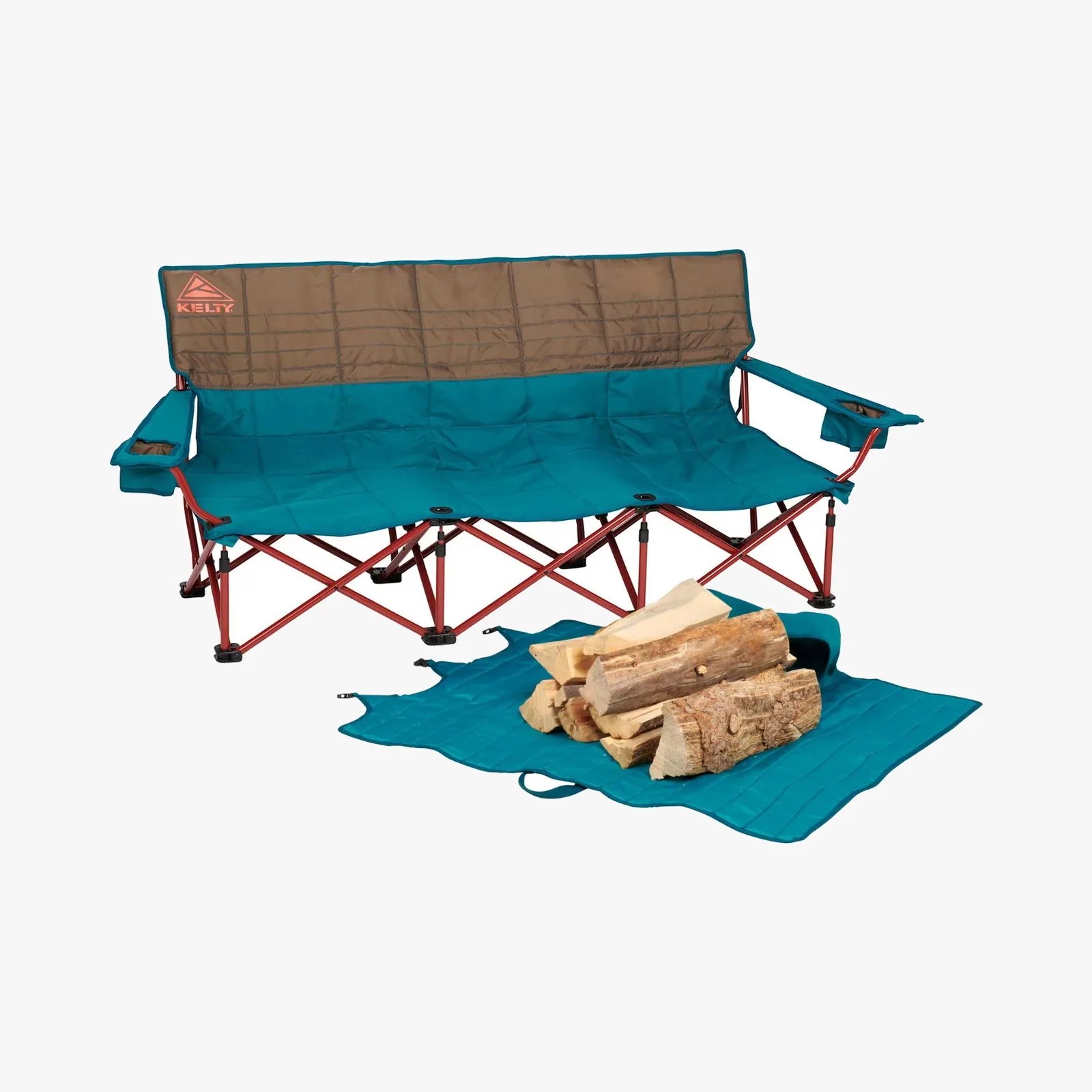 Teal and brown Kelty folding camping loveseat with red metal frame and cup holders on armrests, with firewood on a teal mat.