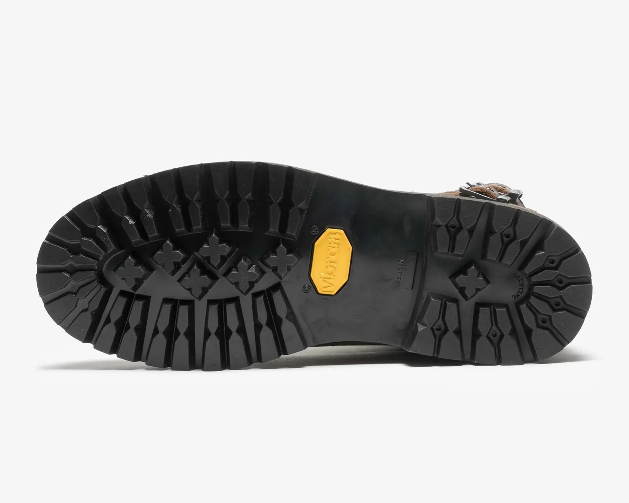 Black Vibram rubber sole with deep treads and a yellow Vibram logo patch.