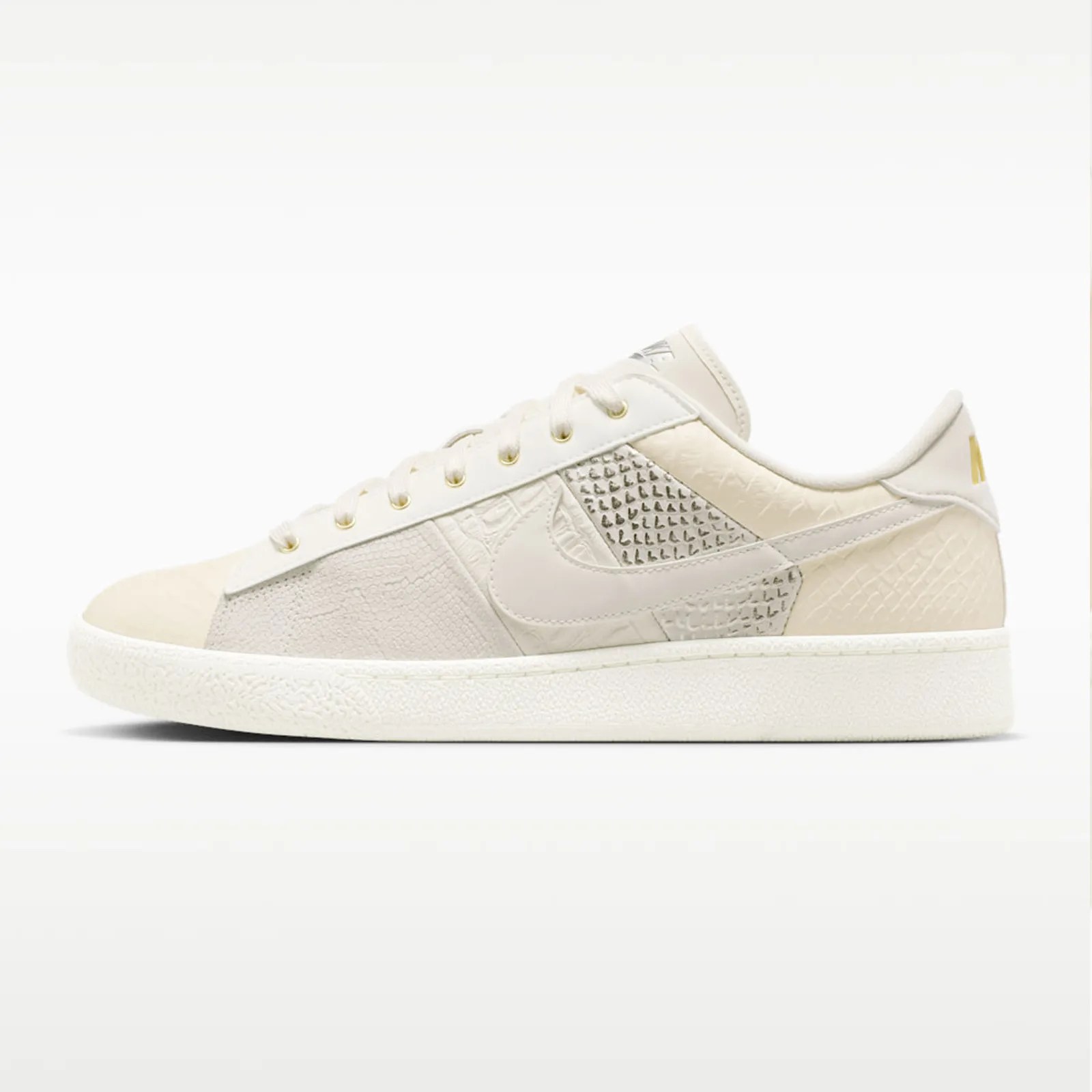 Off-white Nike sneaker with textured panels and a white sole, shown from the side.