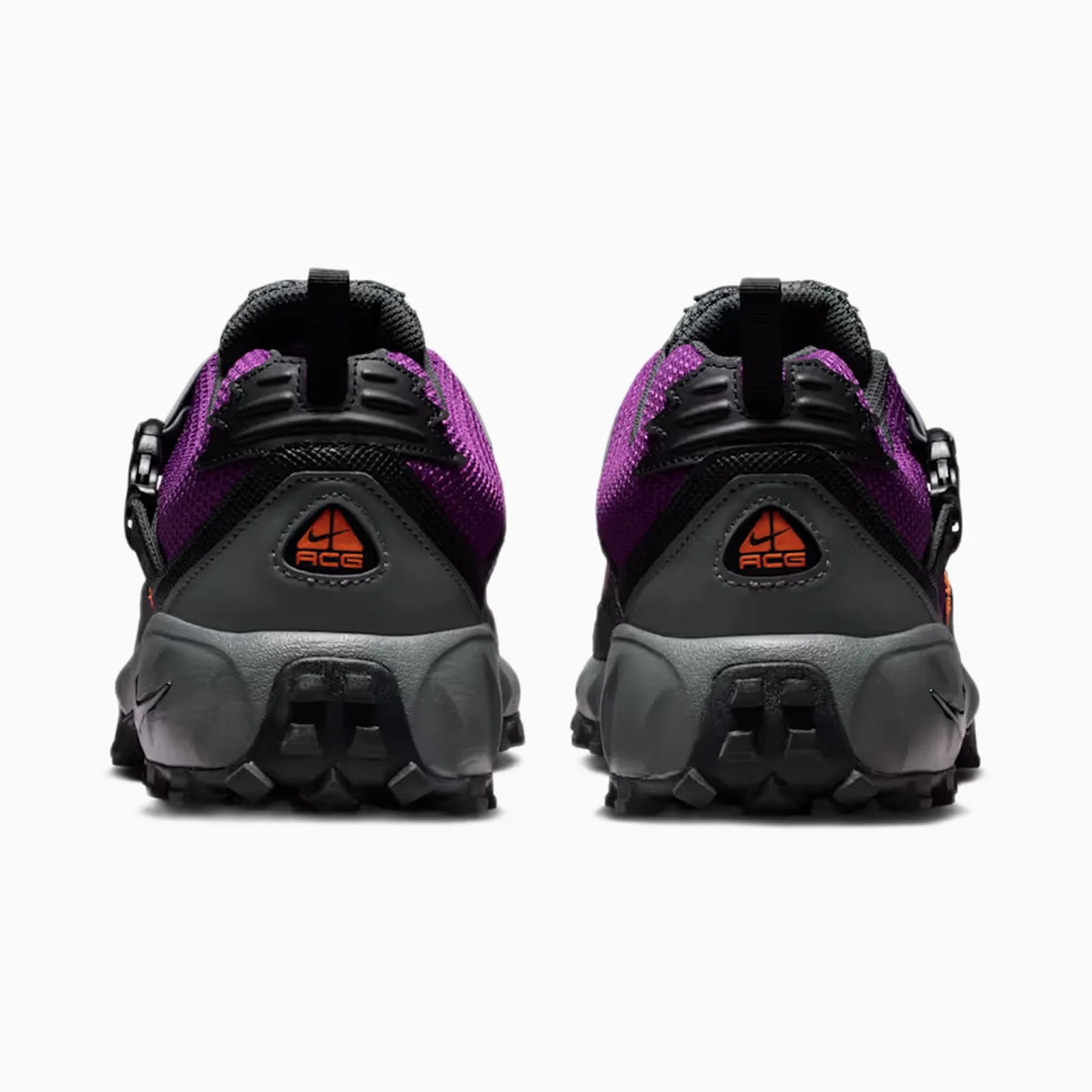 Pair of purple and black Nike ACG trail shoes shown from the back with gray rugged soles.