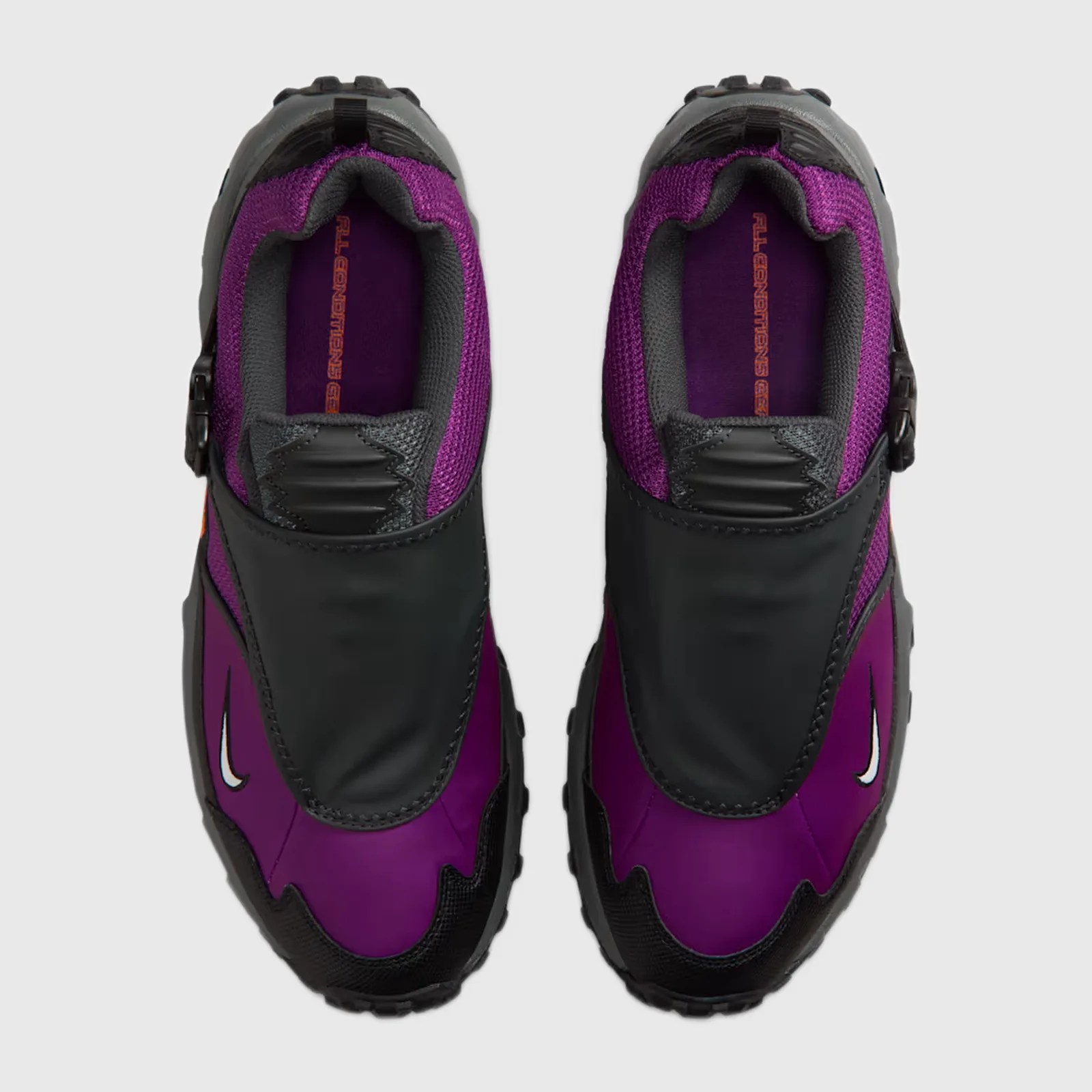 Pair of purple and black Nike sneakers with black protective overlays and white swoosh logos, viewed from above.