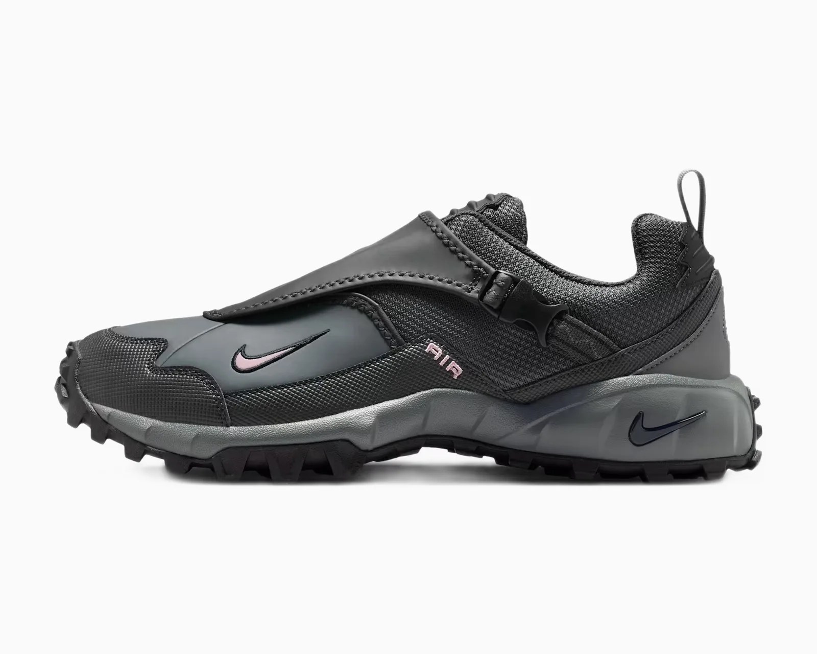 Black and gray Nike sneaker with a protective flap over the laces and rugged sole.