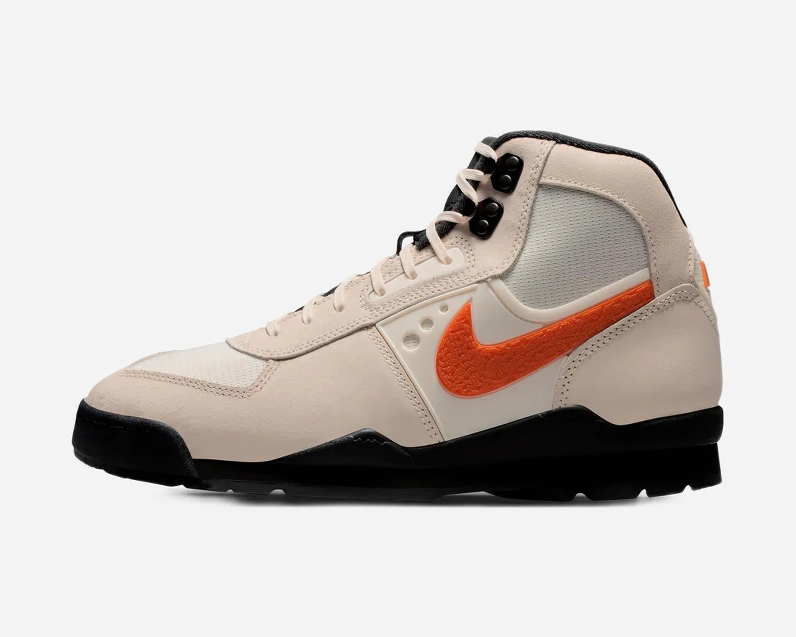 High-top beige sneaker with black sole, orange Nike swoosh, and black lace eyelets.