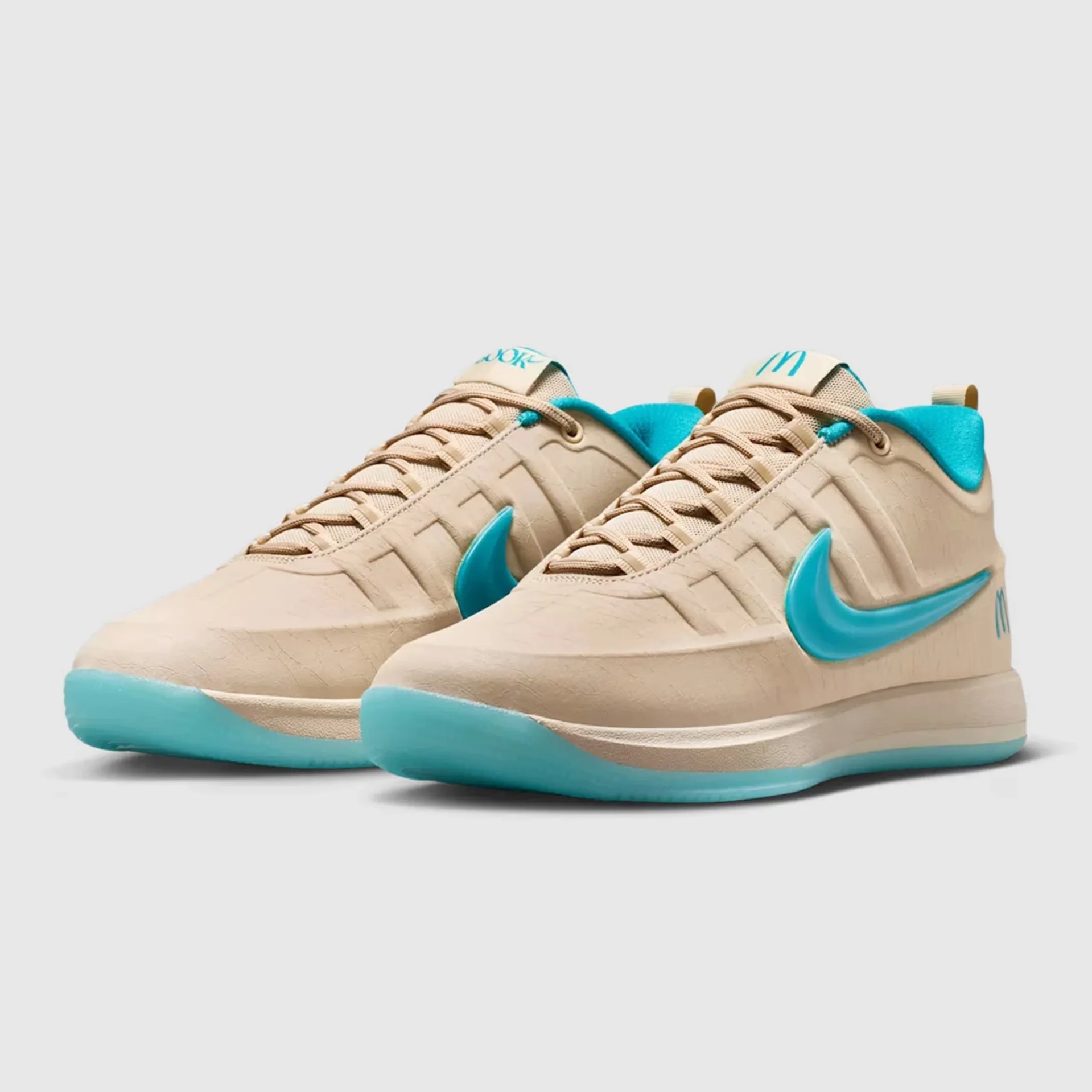 Beige sneakers with turquoise Nike swoosh and inner lining, featuring beige laces and turquoise soles.