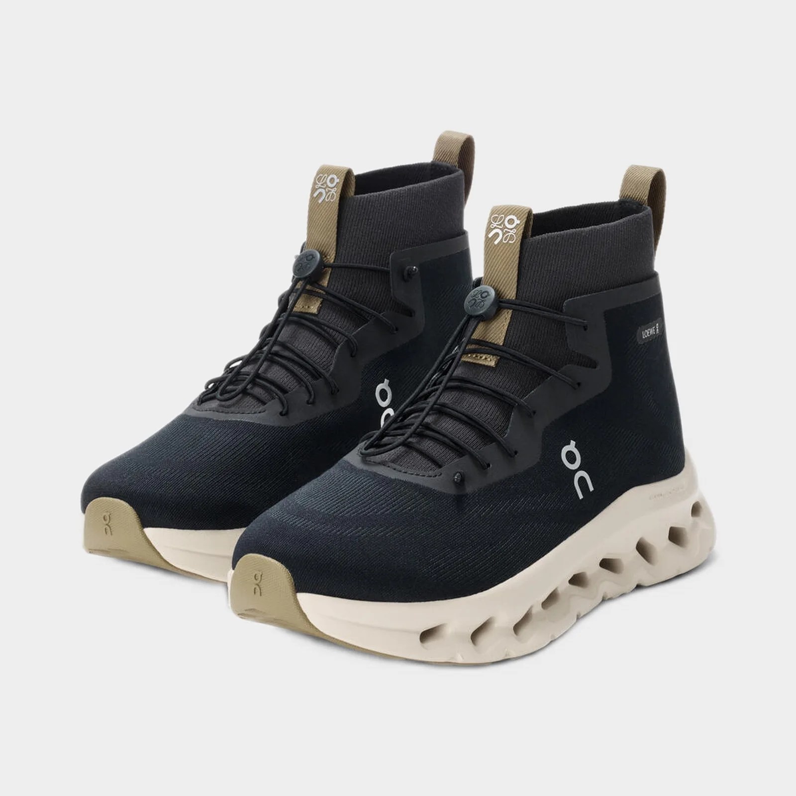 Pair of black and beige high-top sneakers with white soles and pull tabs.