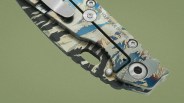 Close-up of a folding knife handle with a blue, beige, and black marbled pattern and a metal clip.