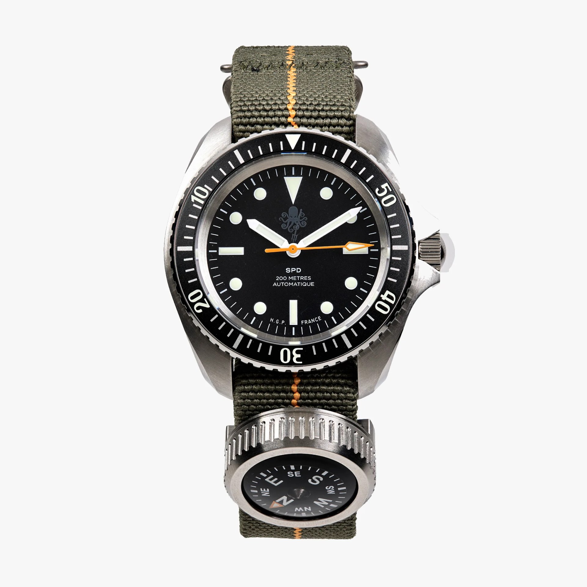 Stainless steel dive watch with black dial and bezel, green fabric strap with orange stitching, and attached compass.