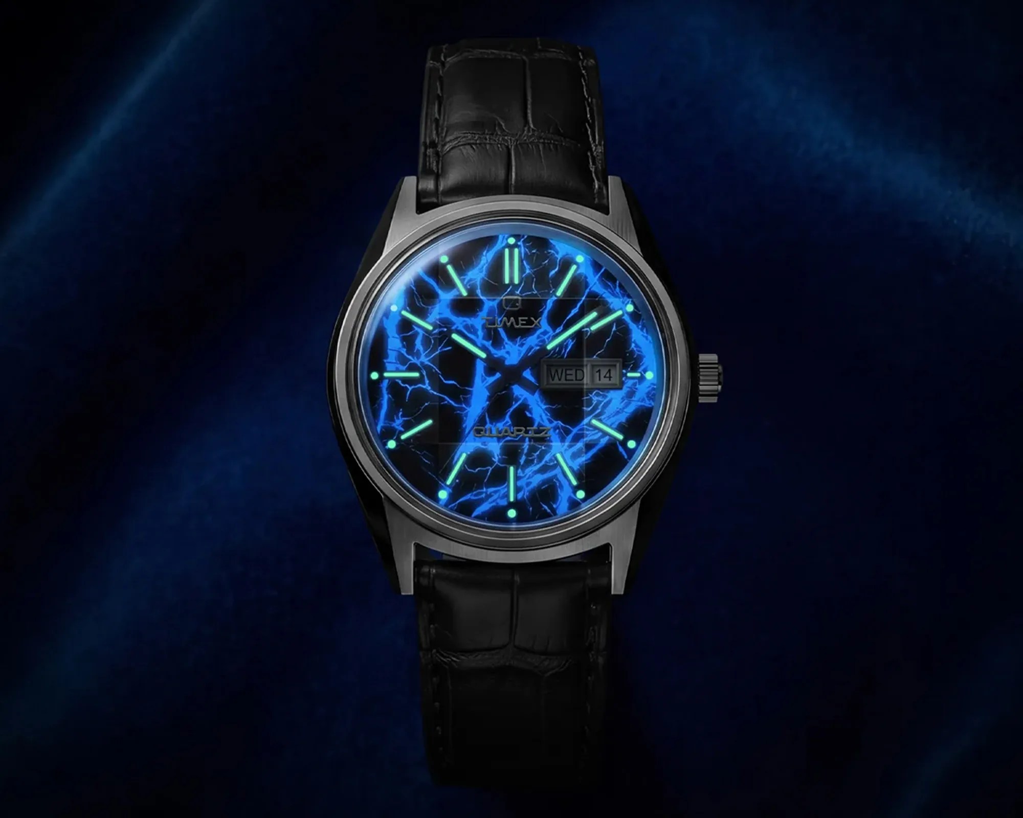 Timex wristwatch with black leather strap and glowing blue lightning-patterned dial showing day and date.