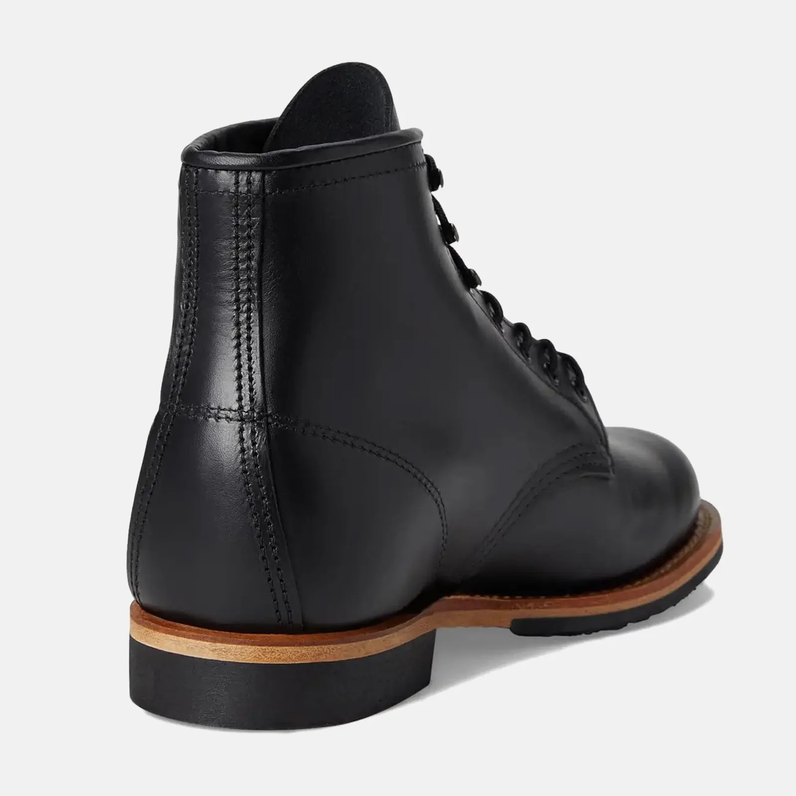 Black leather lace-up boot with wooden sole and black rubber heel viewed from the back.