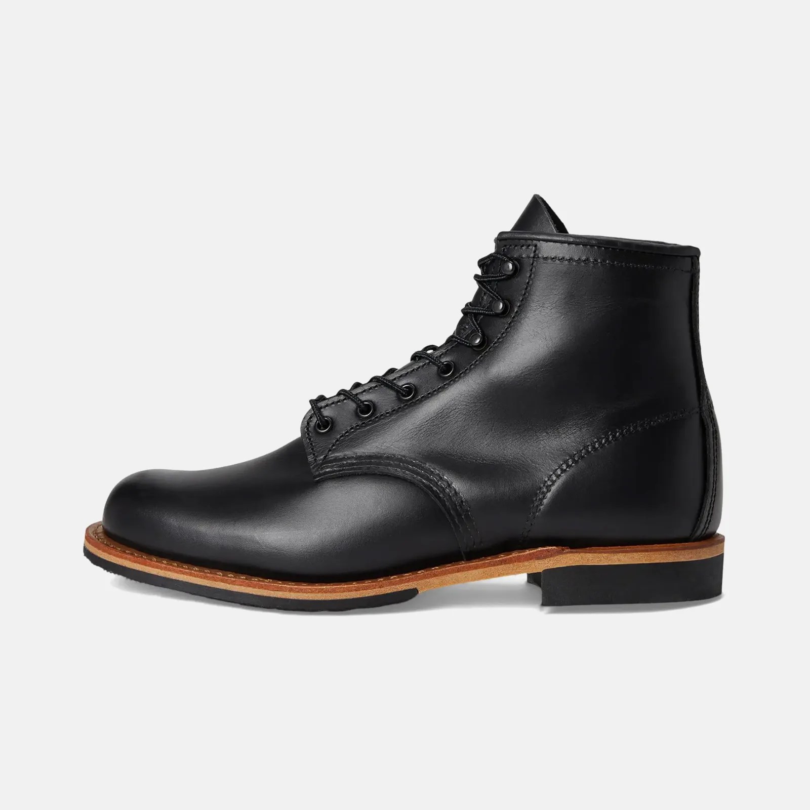 Black leather lace-up ankle boot with brown welt and black sole on a white background.