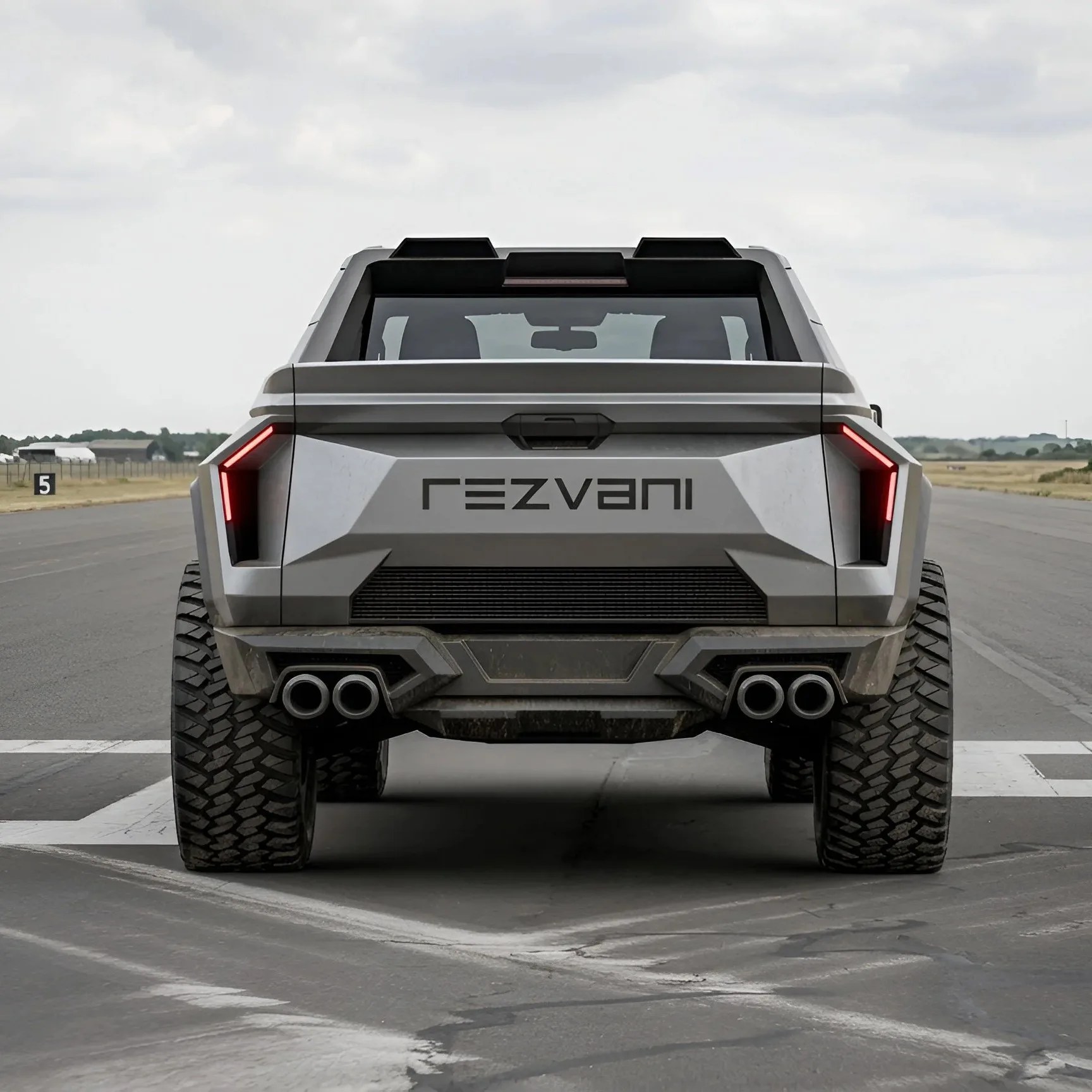 Rear view of a silver Rezvani SUV with large off-road tires and angular taillights on a paved road.