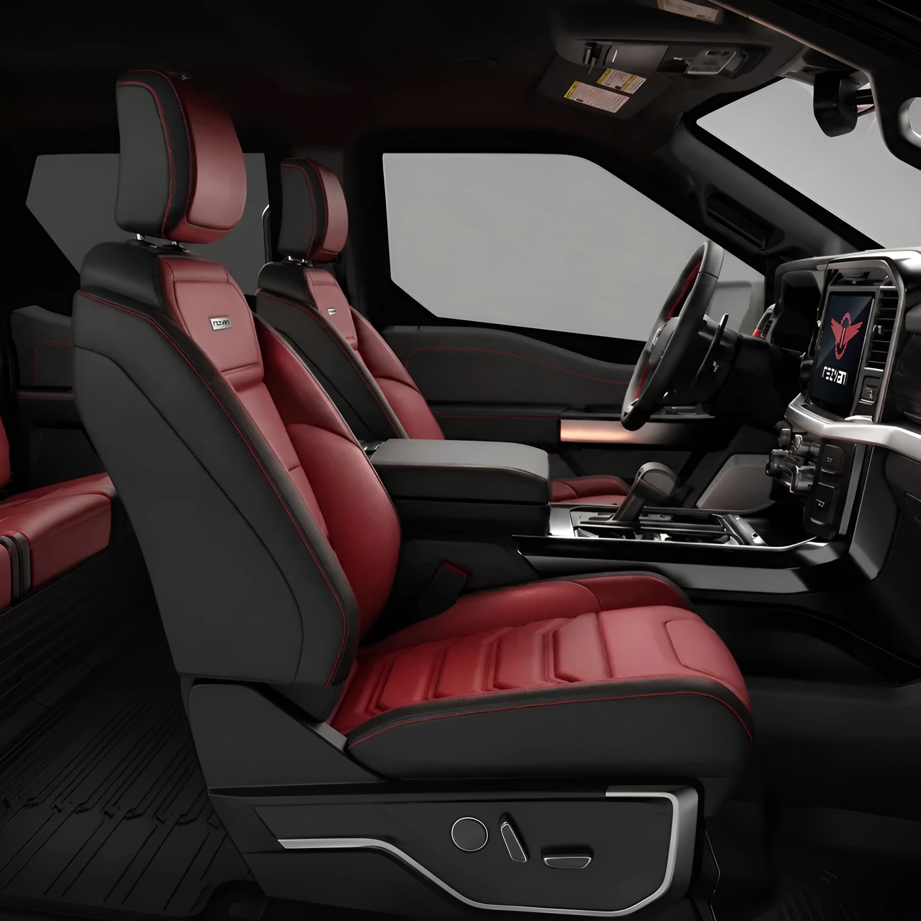 Two-tone black and red leather car seats with red stitching inside a vehicle cabin.