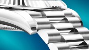 Close-up of a polished and brushed stainless steel watch bracelet and case against a blue background.