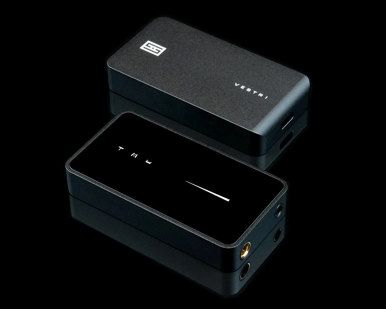 Two black rectangular electronic devices with rounded edges, one showing the brand name "Vestri" and the other with a glossy top and ports on the side.