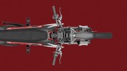 Top-down view of a red and black off-road motorcycle with knobby tires on a red background.