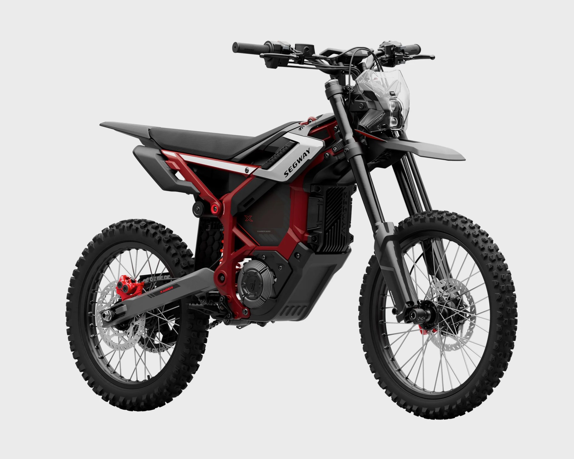 Red and black Segway electric dirt bike with knobby tires and clear front headlight shield.