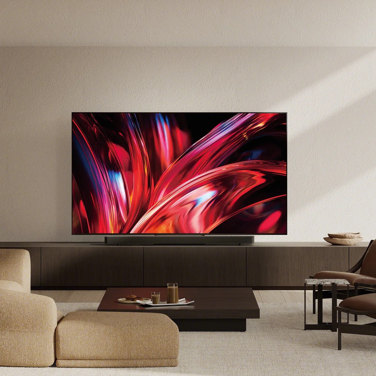 Flat-screen TV with vibrant red and blue abstract display on a dark wood media console in a modern living room.