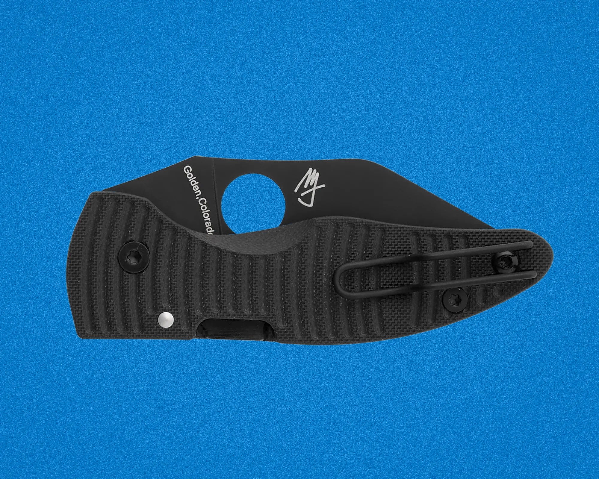 Black textured folding knife handle with a partially visible blade marked "Golden, Colorado" and a clip on a blue background.